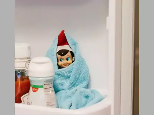 The elf is resting in the refrigerator